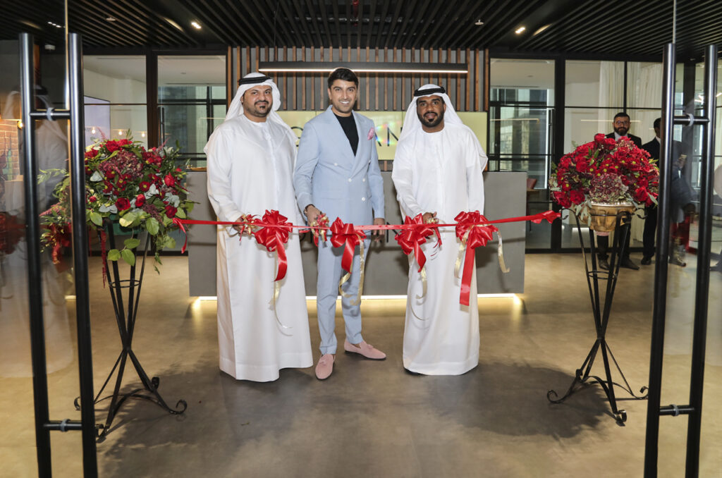 Samir Salya cutting the ribbon at Giovanni Office Open Day alongside two Arab investors or guests of honour - a moment of celebration and global collaboration