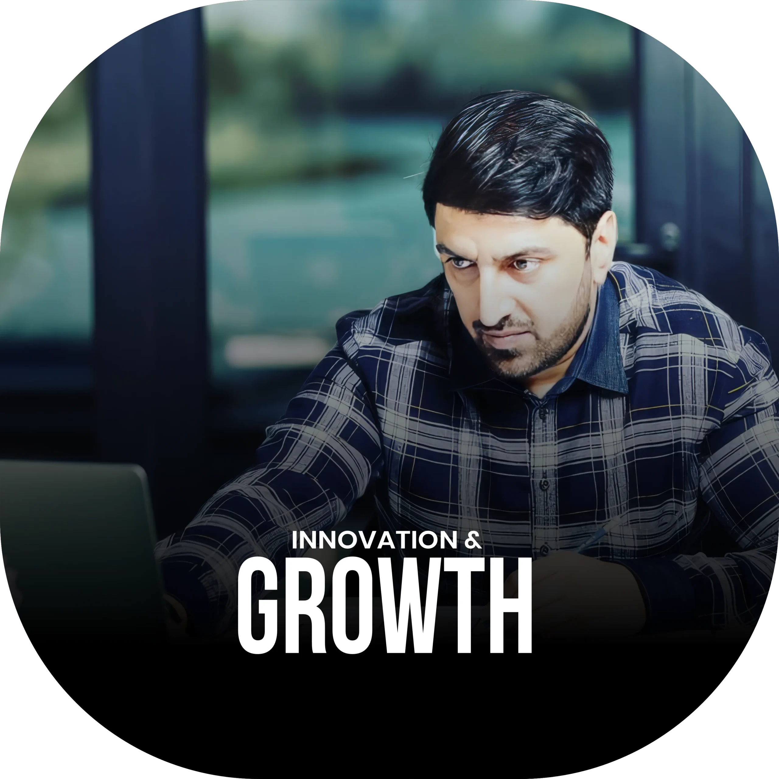Candid photo of Samir Salya working at his desk, looking at a laptop - podcast promo for “Innovation & Growth” on tech, strategy, and adaptability